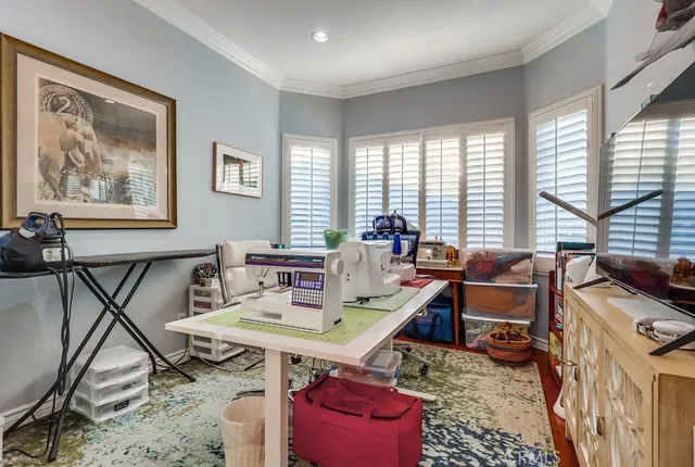 a view of a workspace with furniture and a window