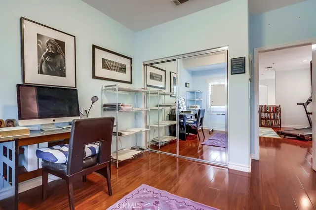 a spacious bedroom with a bed a couch and a flat screen tv