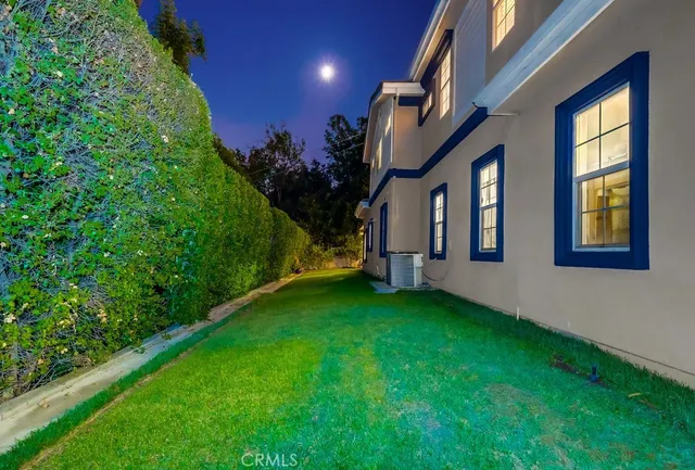 a view of a house with a yard porch and sitting area