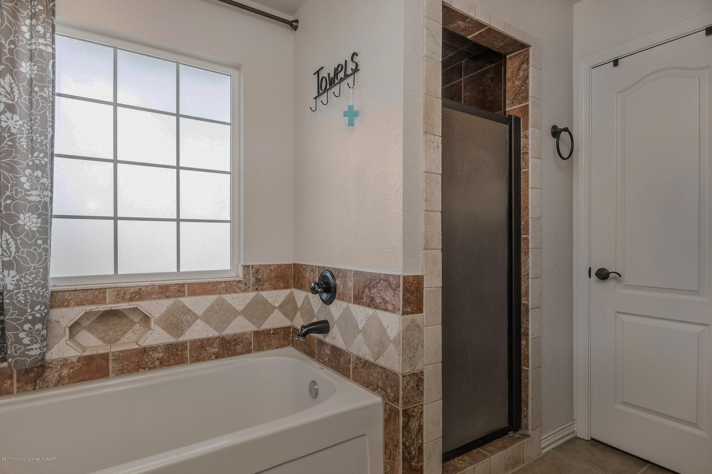 5308 Pleasant Court Amarillo, TX 79110 - Photo 12 of 19 a bathroom with a bathtub and shower