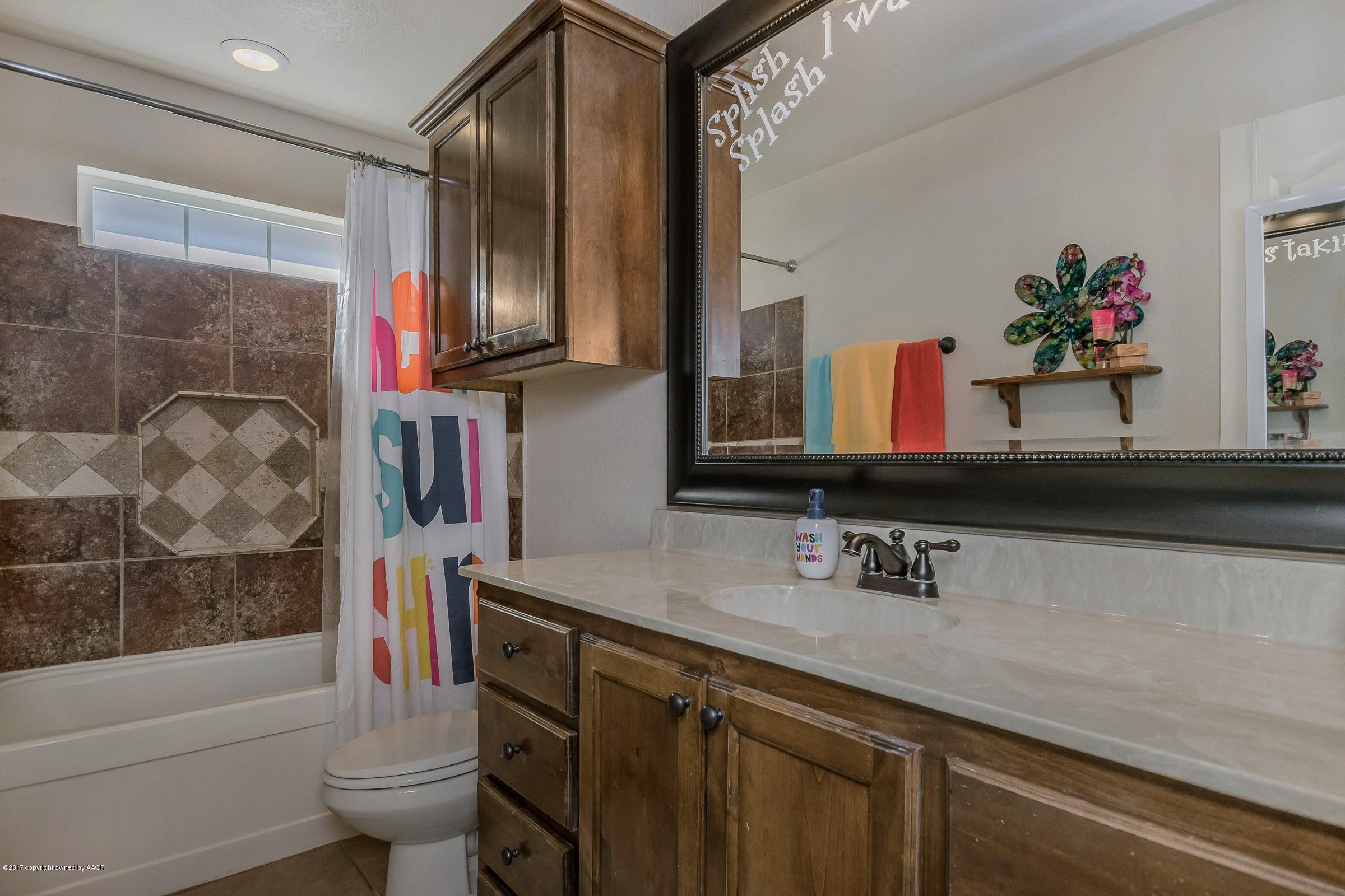 5308 Pleasant Court Amarillo, TX 79110 - Photo 14 of 19 a bathroom with a sink a toilet and shower