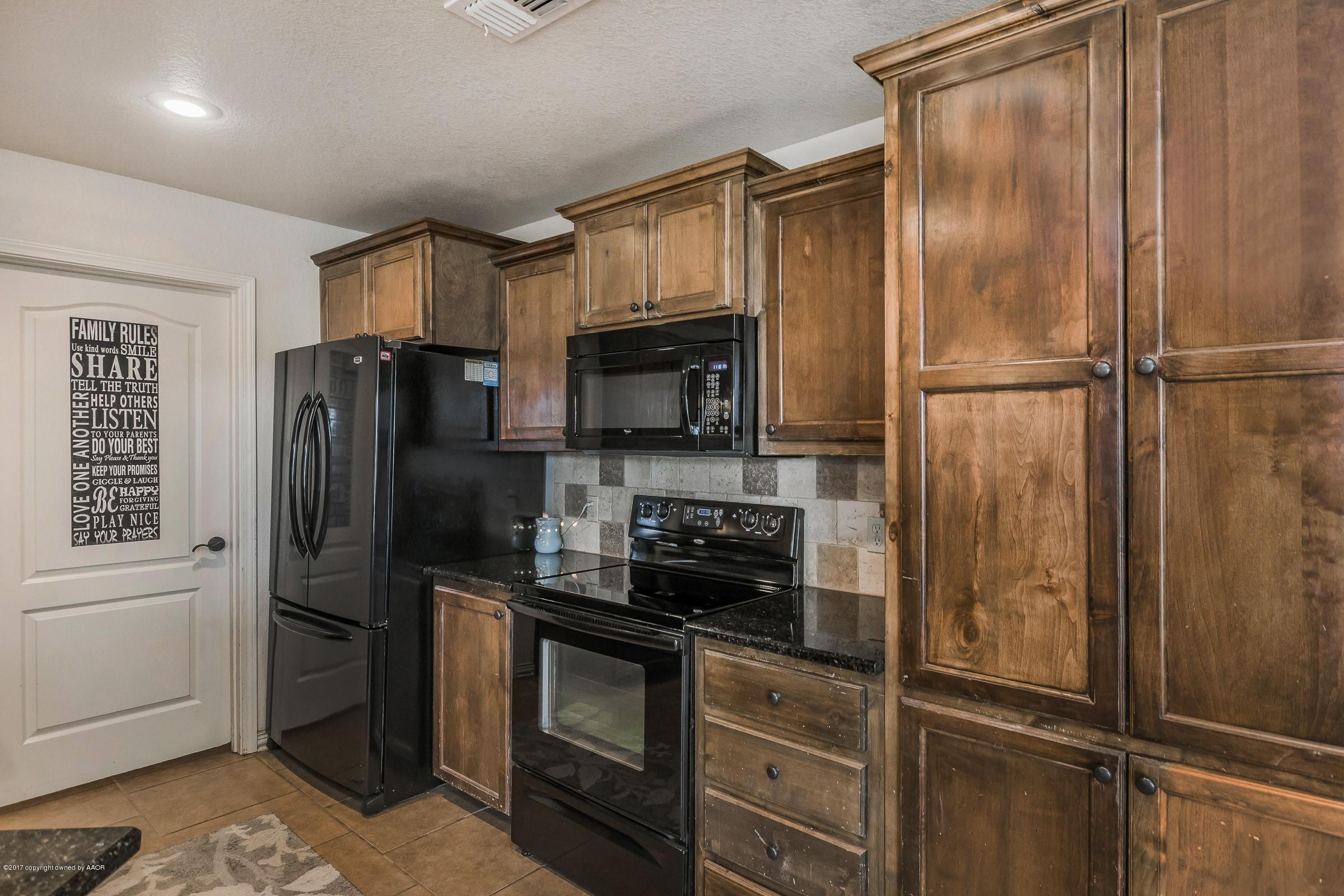 5308 Pleasant Court Amarillo, TX 79110 - Photo 3 of 19 a kitchen with stainless steel appliances granite countertop a refrigerator and a stove top oven