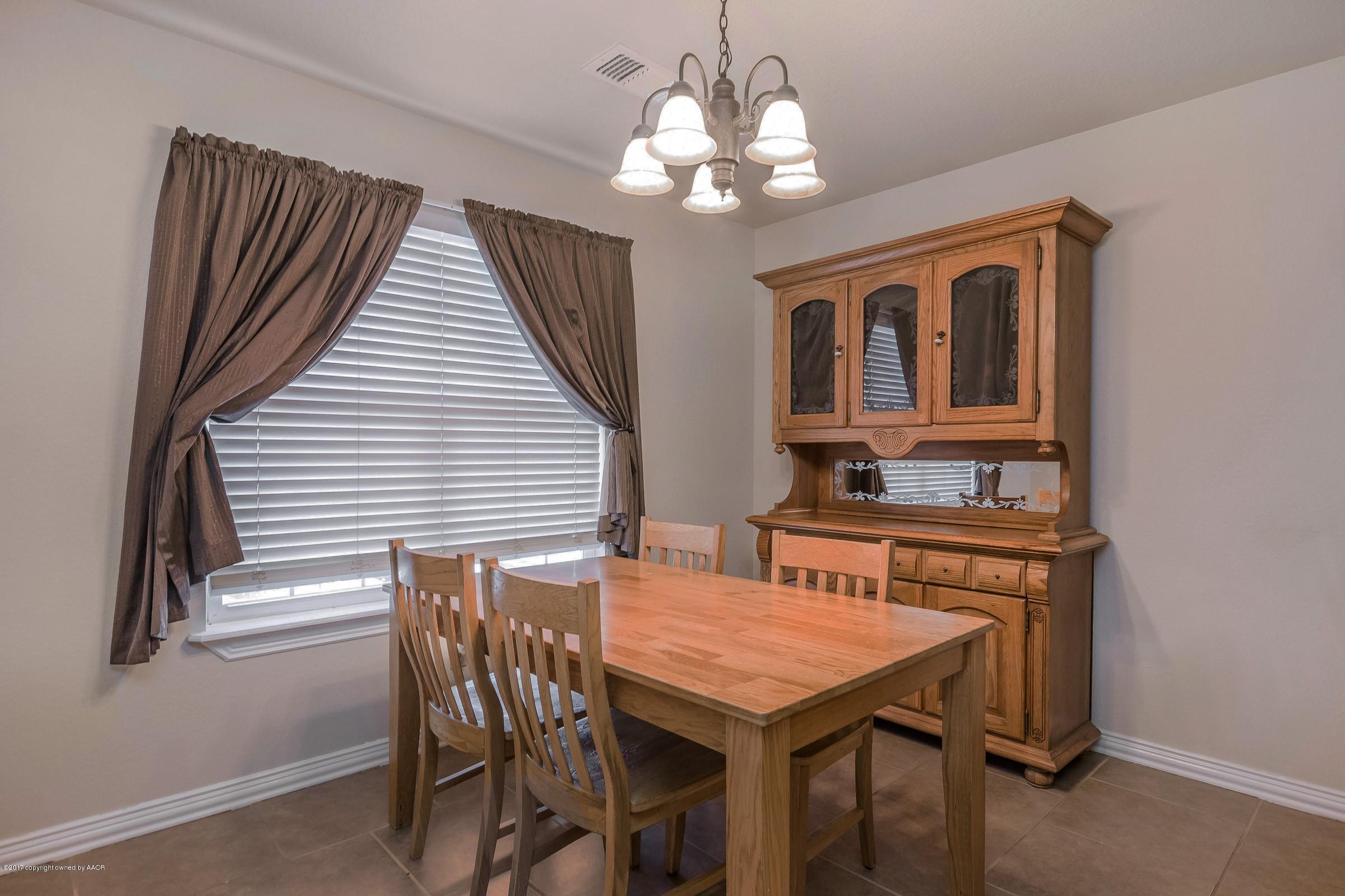 5308 Pleasant Court Amarillo, TX 79110 - Photo 8 of 19 a view of a dining room with furniture and chandelier