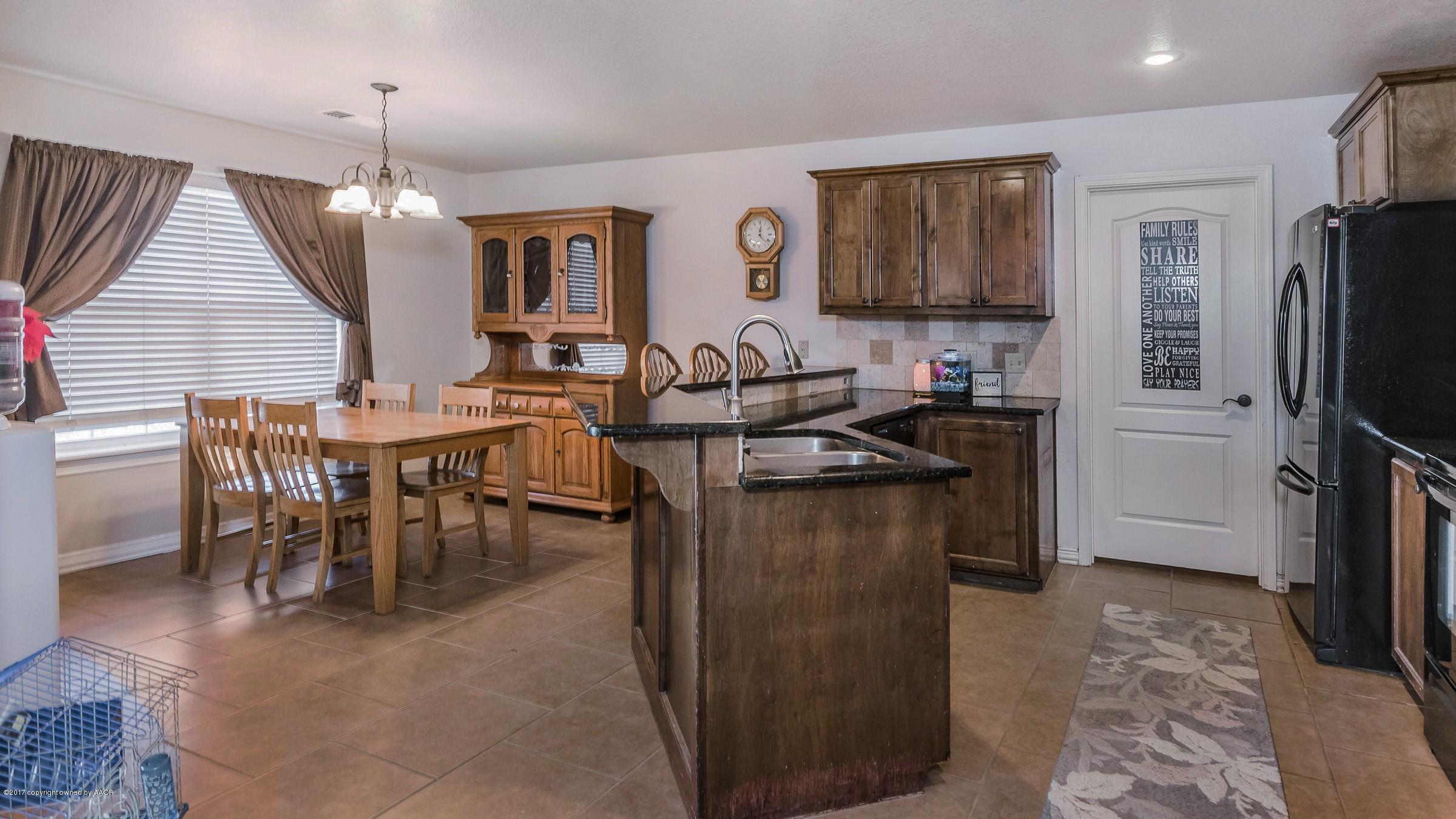 5308 Pleasant Court Amarillo, TX 79110 - Photo 9 of 19 a kitchen with stainless steel appliances granite countertop a refrigerator a stove a sink a dining table and chairs