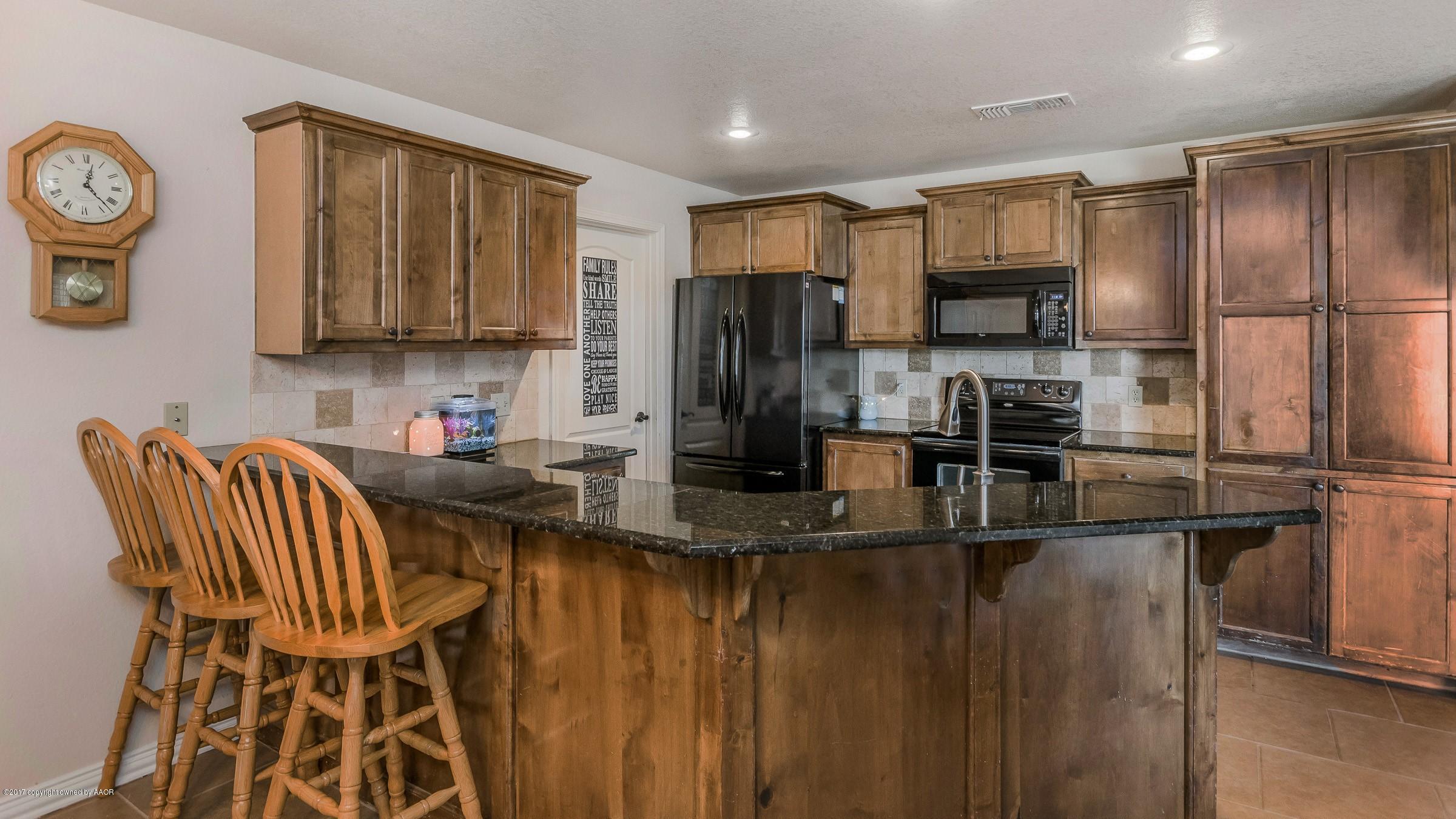 5308 Pleasant Court Amarillo, TX 79110 - Photo 10 of 19 a kitchen with a refrigerator and a stove top oven
