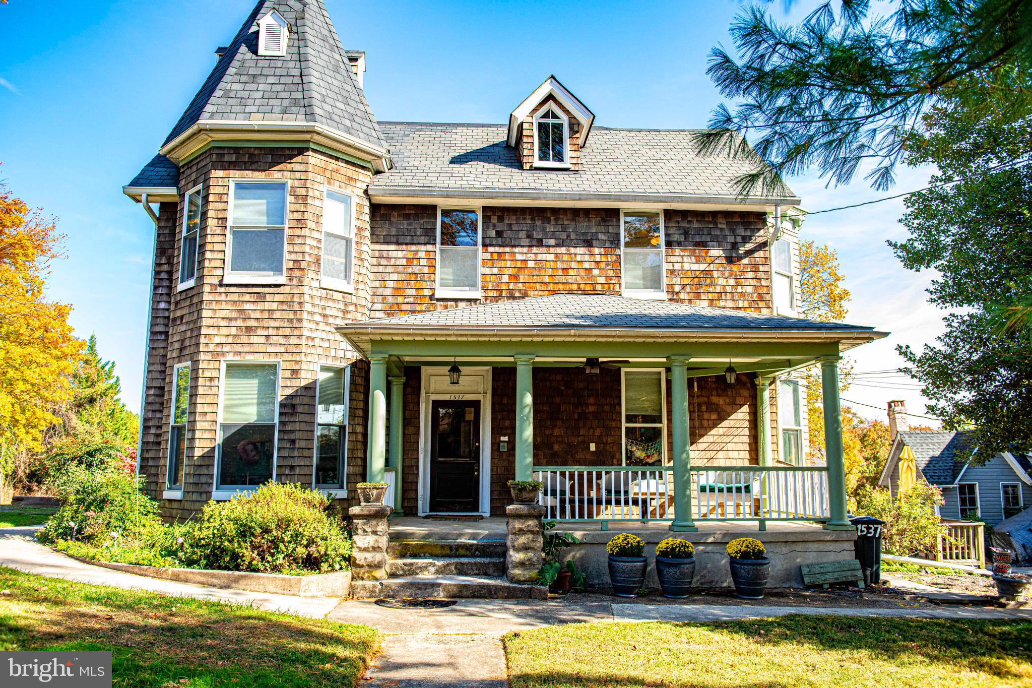 a front view of a house with swimming pool and glass windows