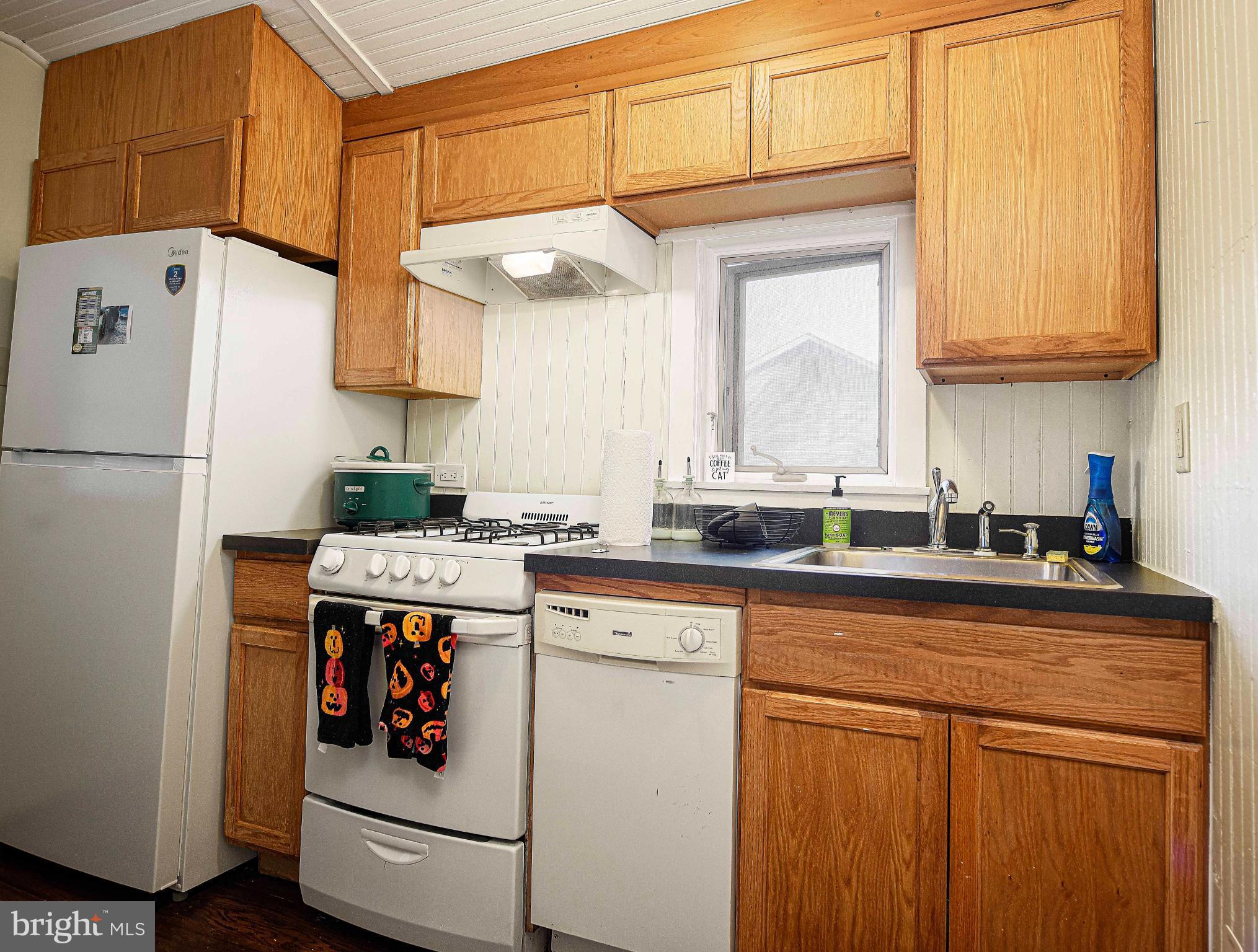 1537 South Rolling Road Halethorpe, MD 21227 - Photo 15 of 24 a kitchen with a sink a refrigerator and cabinets