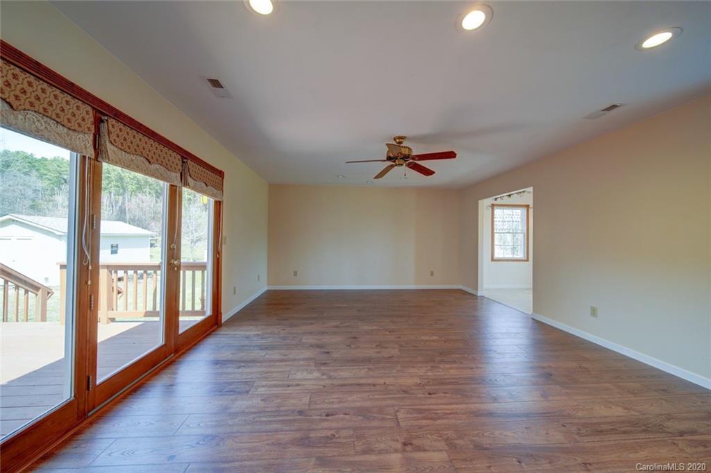 36435 Finger Road Mount Pleasant, NC 28124 - Photo 12 of 37 a view of an empty room with a window and wooden floor