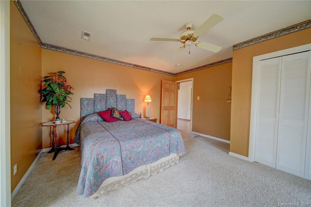 36435 Finger Road Mount Pleasant, NC 28124 - Photo 20 of 37 a living room with a bed and a chandelier