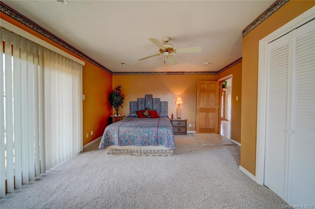 36435 Finger Road Mount Pleasant, NC 28124 - Photo 21 of 37 a bedroom with a bed and a chandelier