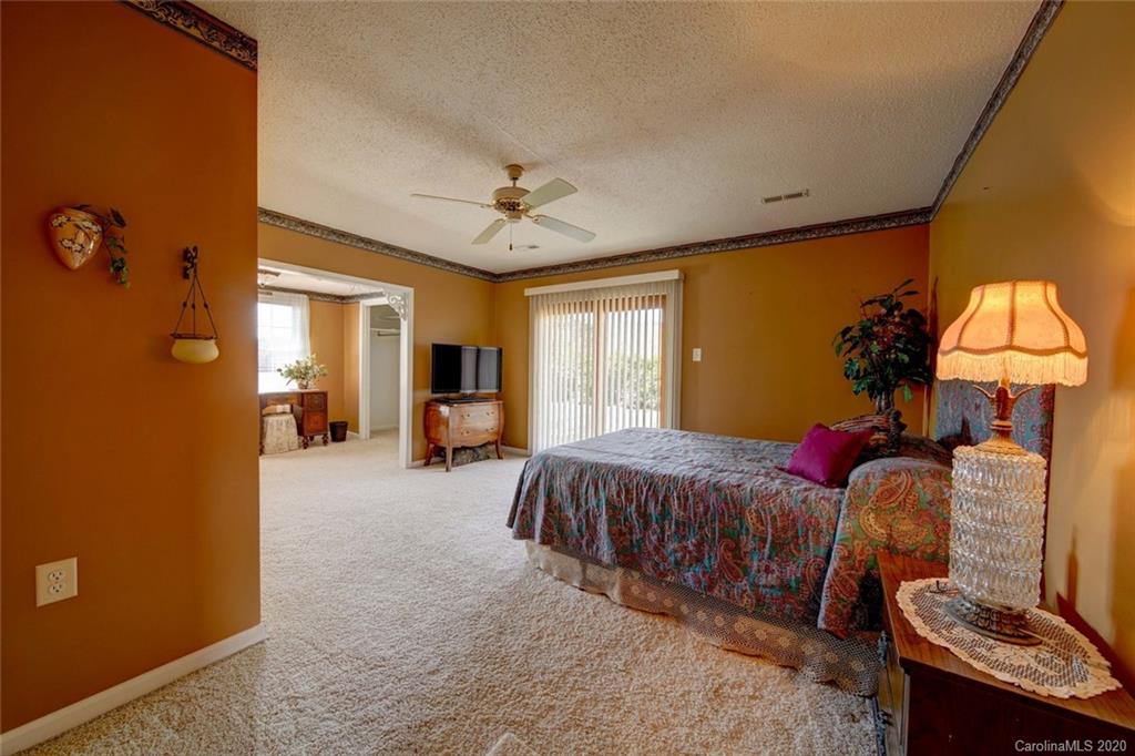 36435 Finger Road Mount Pleasant, NC 28124 - Photo 22 of 37 a spacious bedroom with a bed and dresser with mirror