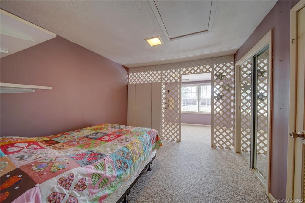 36435 Finger Road Mount Pleasant, NC 28124 - Photo 28 of 37 a bedroom with a bed and a chandelier