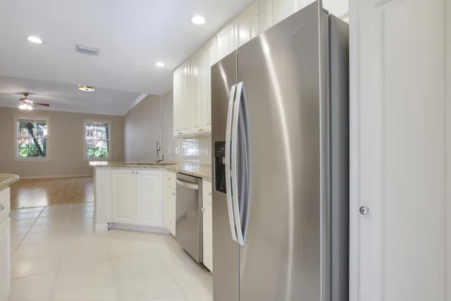 a view of a kitchen with a refrigerator and a sink