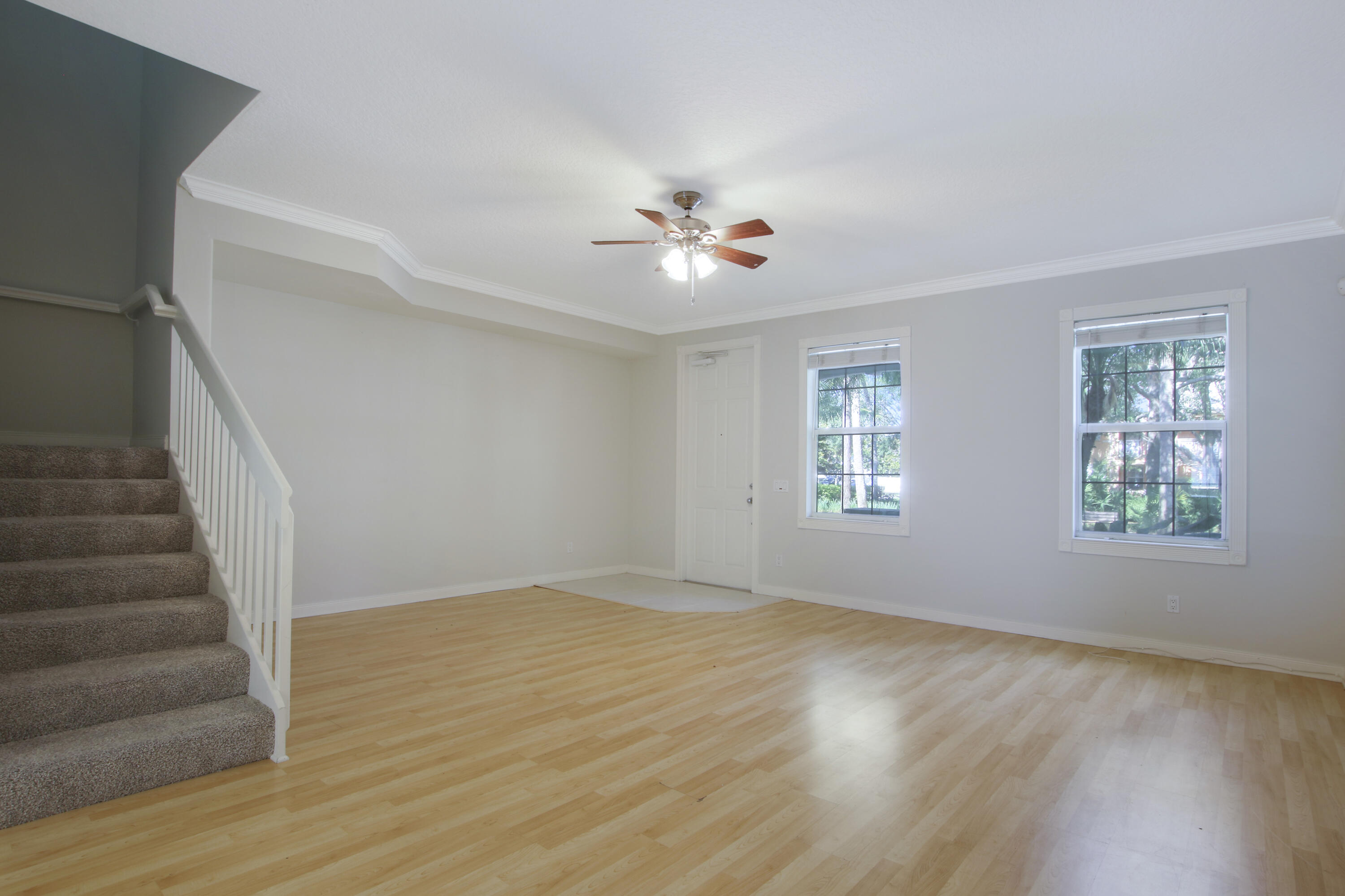 3057 East Community Drive Jupiter, FL 33458 - Photo 9 of 23 a view of an empty room with a window and wooden floor