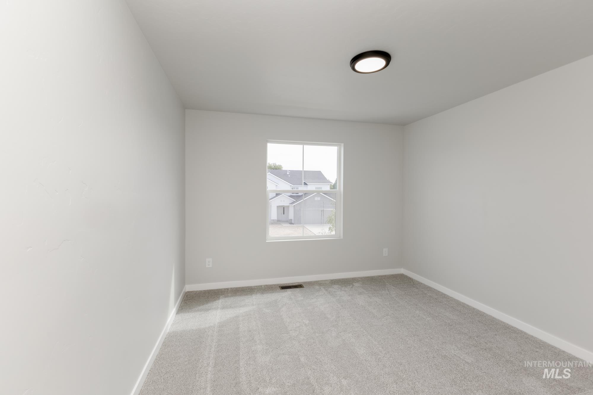 5303 Castleton Avenue Nampa, ID 83686 - Photo 18 of 26 Unfurnished room with light carpet and baseboards