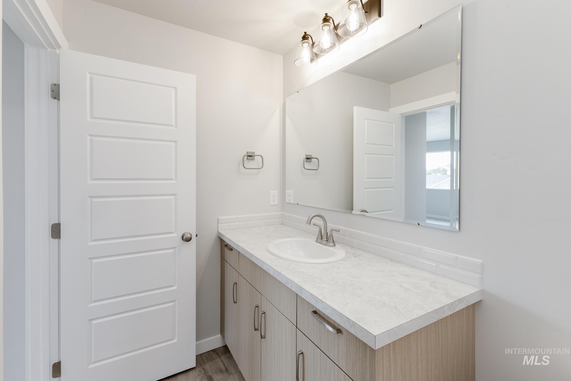 5303 Castleton Avenue Nampa, ID 83686 - Photo 20 of 26 Bathroom with vanity and light wood-style flooring