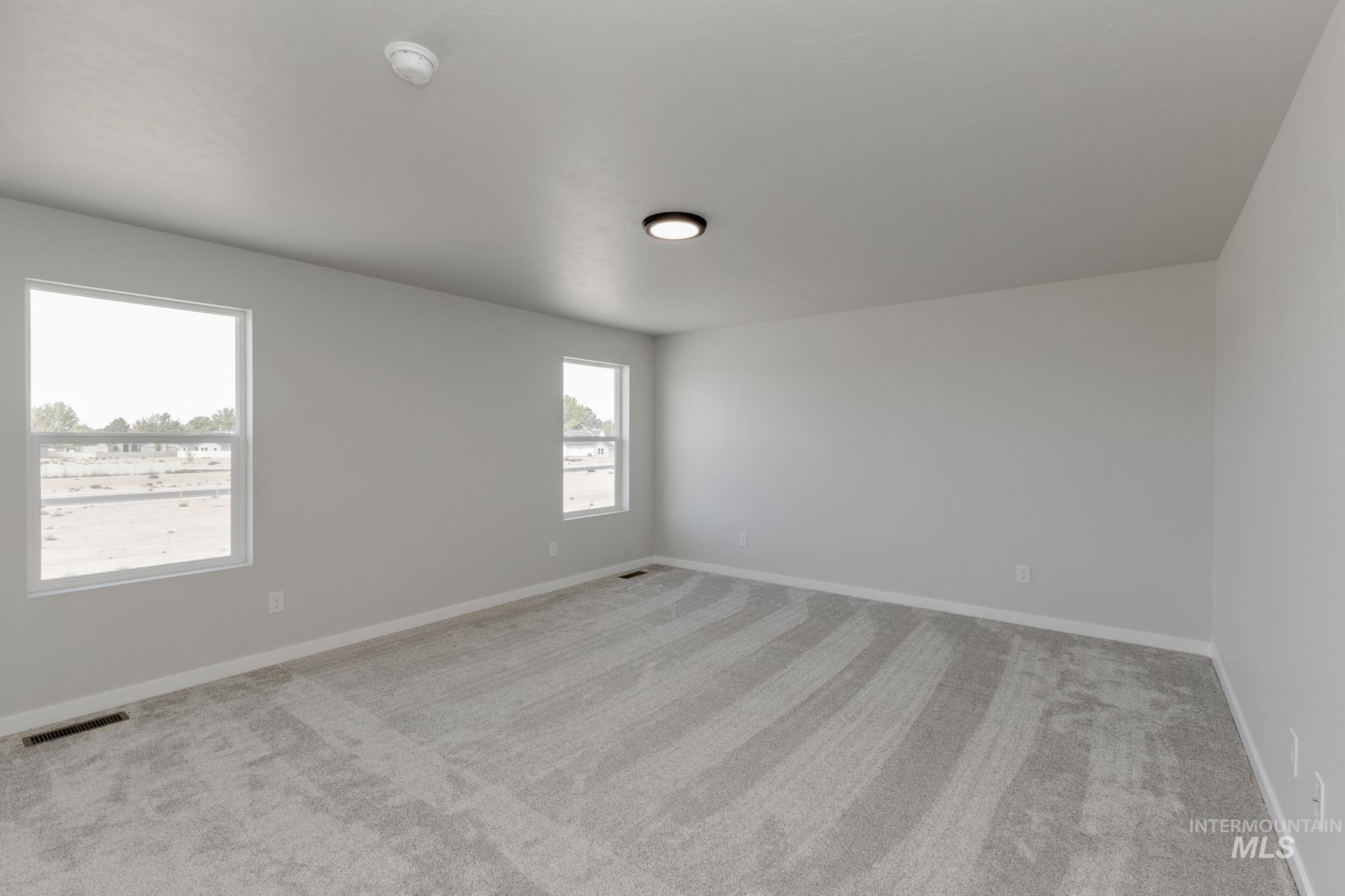 5303 Castleton Avenue Nampa, ID 83686 - Photo 23 of 26 Empty room featuring light colored carpet and baseboards