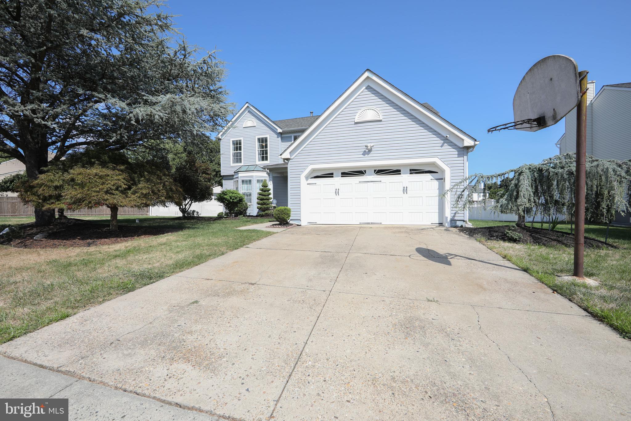 Spacious driveway with basketball net