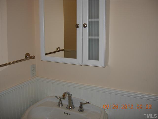 309 Hudson Street Raleigh, NC 27608 - Photo 11 of 17 a bathroom with a sink and a mirror