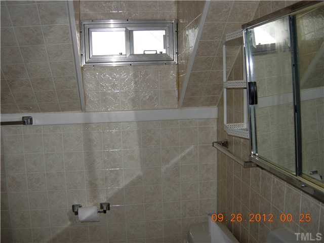 309 Hudson Street Raleigh, NC 27608 - Photo 12 of 17 a bathroom with a glass shower door