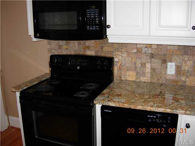 309 Hudson Street Raleigh, NC 27608 - Photo 7 of 17 a kitchen with a sink and a microwave