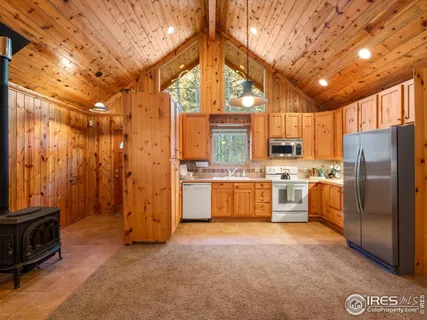 a large kitchen with cabinets and stainless steel appliances