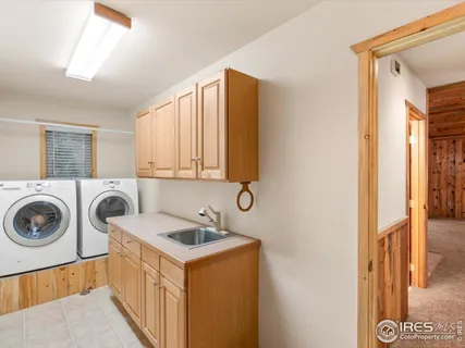 a utility room with sink dryer and washer