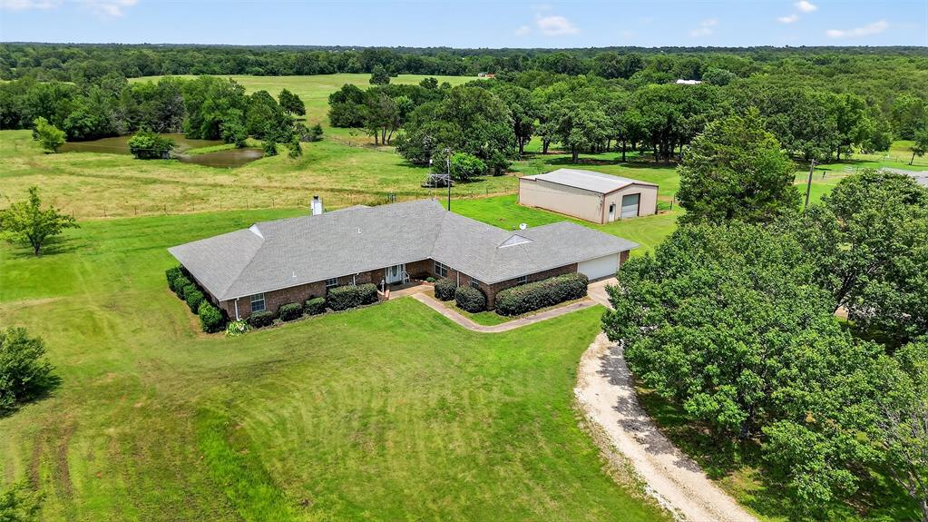 an aerial view of a house with pool
