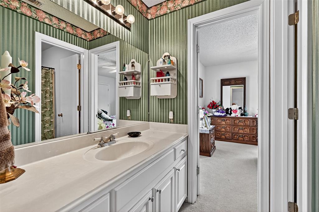 929 County Line Church Road Whitesboro, TX 76273 - Photo 22 of 38 a en suite bathroom with a sink and a mirror