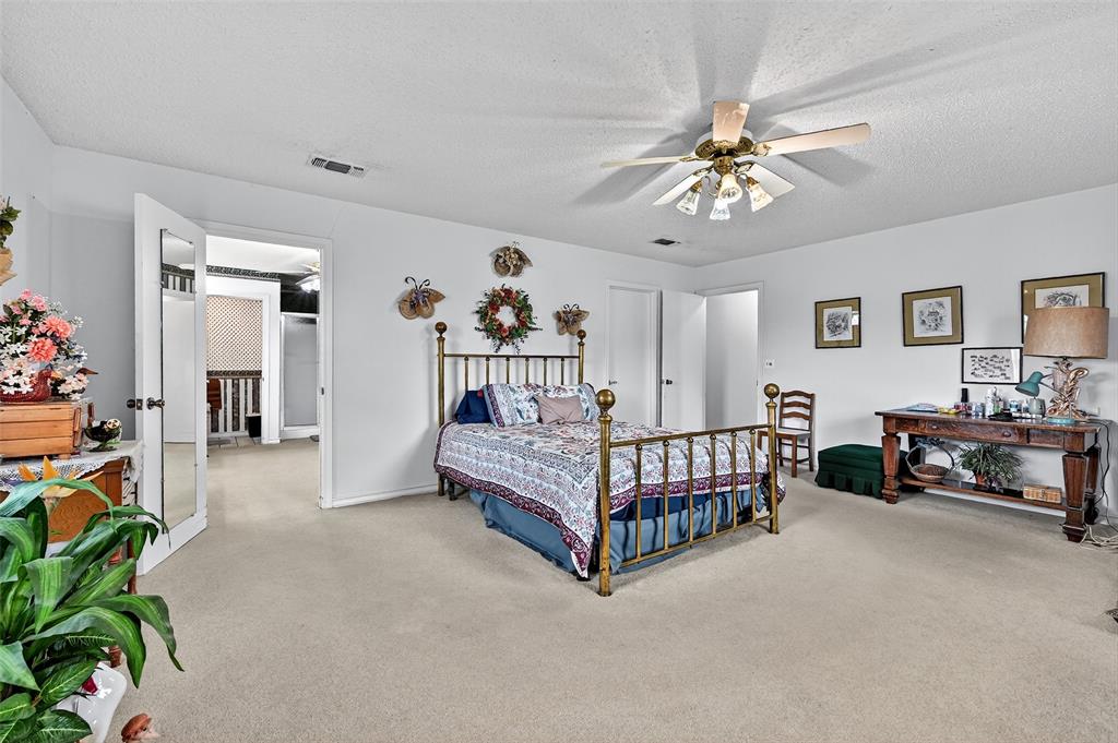 929 County Line Church Road Whitesboro, TX 76273 - Photo 25 of 38 a bedroom with furniture and a chandelier