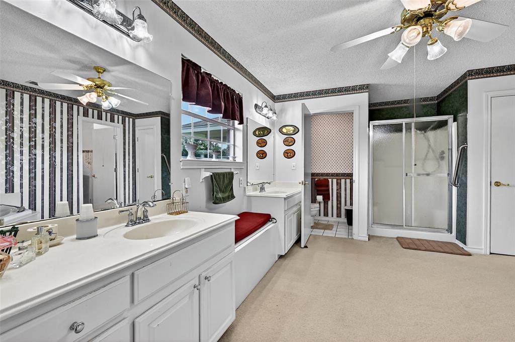 929 County Line Church Road Whitesboro, TX 76273 - Photo 26 of 38 a en suite spacious bathroom with a double vanity sinks a vanity a lamp and a shower