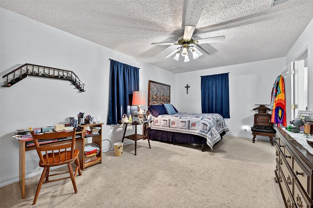 929 County Line Church Road Whitesboro, TX 76273 - Photo 32 of 38 a bedroom with furniture and a ceiling fan