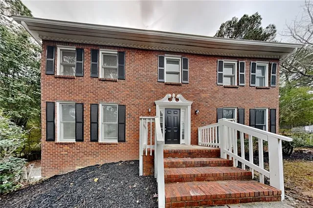 a front view of a house with stairs
