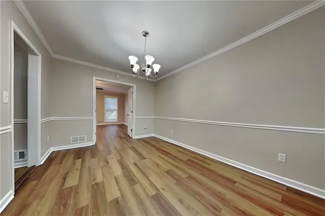 a view of livingroom with hallway and wooden floor