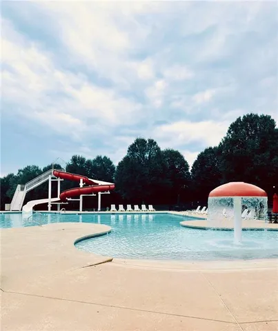 a view of a swimming pool with a yard