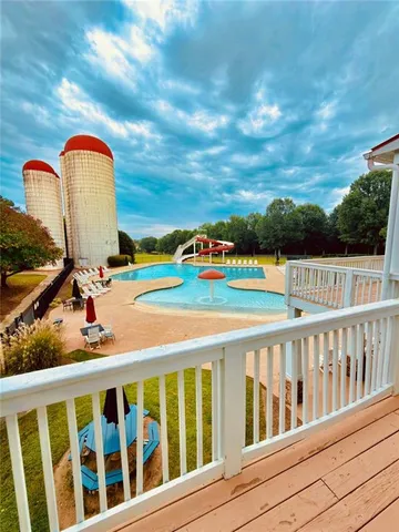 a view of a balcony with wooden floor & fence