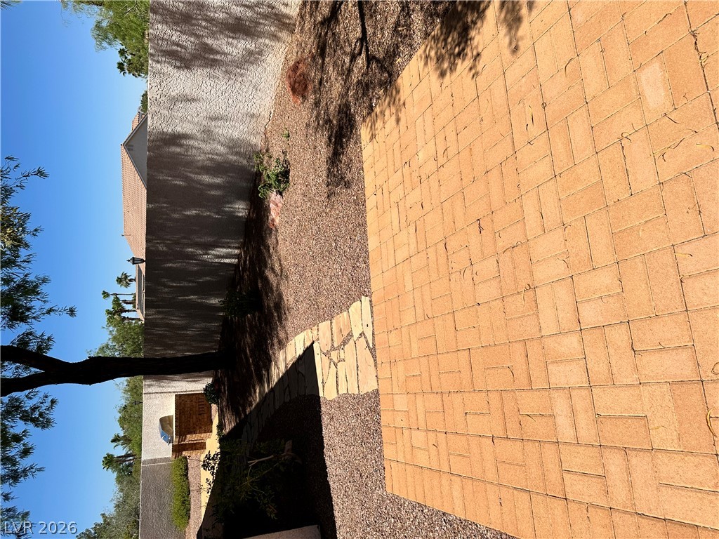 1922 Thunder Ridge Circle Henderson, NV 89012 - Photo 23 of 27 A well-maintained paved walkway and gravel landscaping enhance the property's exterior appeal.
