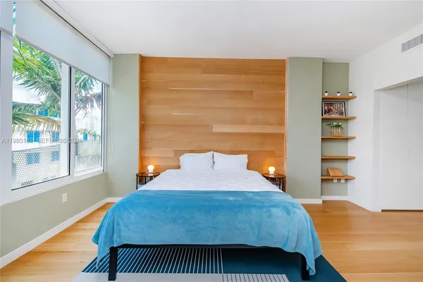 a bedroom with a bed and a window