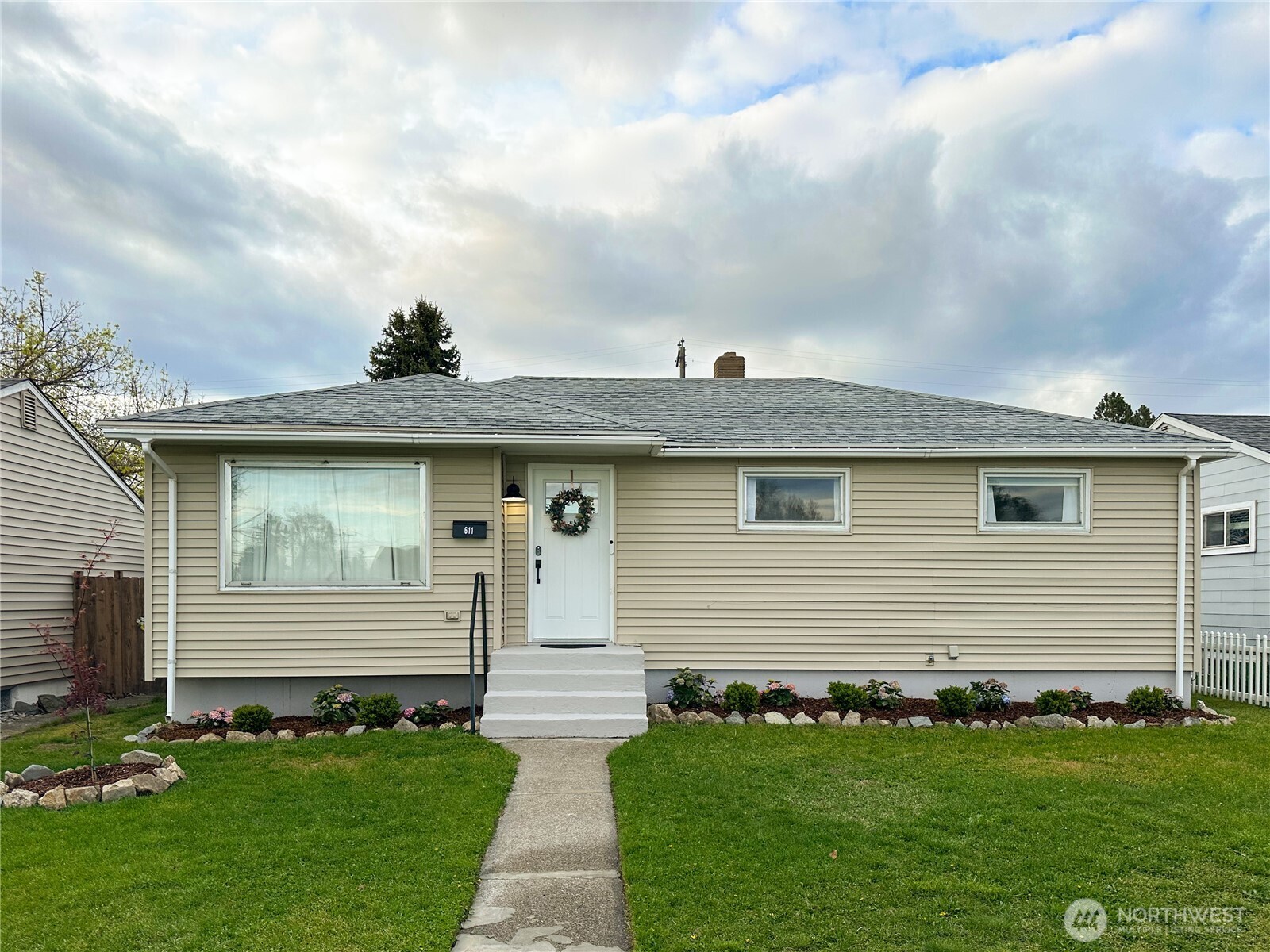 611 East Joseph Avenue Spokane, WA 99208 - Photo 1 of 29 a front view of a house with a garden