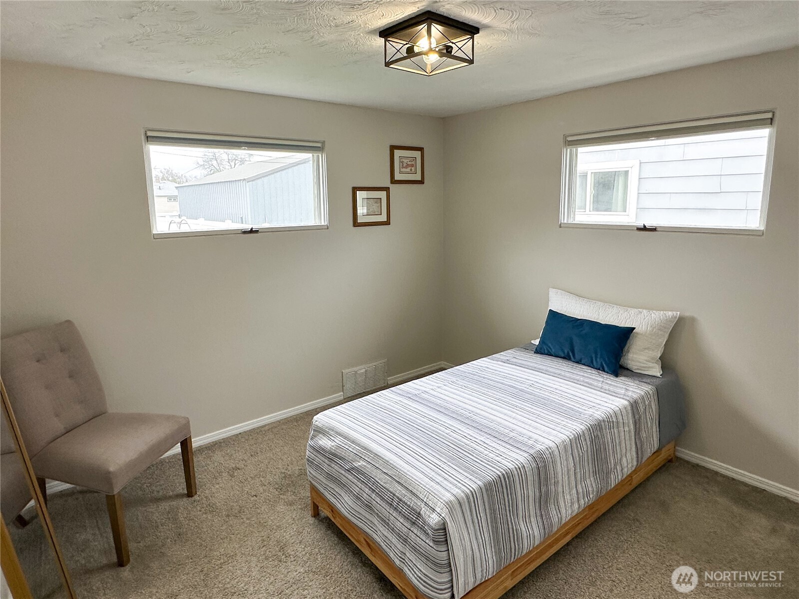 611 East Joseph Avenue Spokane, WA 99208 - Photo 11 of 29 a bedroom with a bed and a chair
