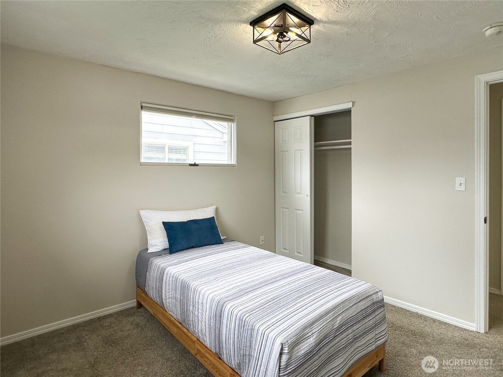 611 East Joseph Avenue Spokane, WA 99208 - Photo 12 of 29 a bedroom with a bed and a chandelier