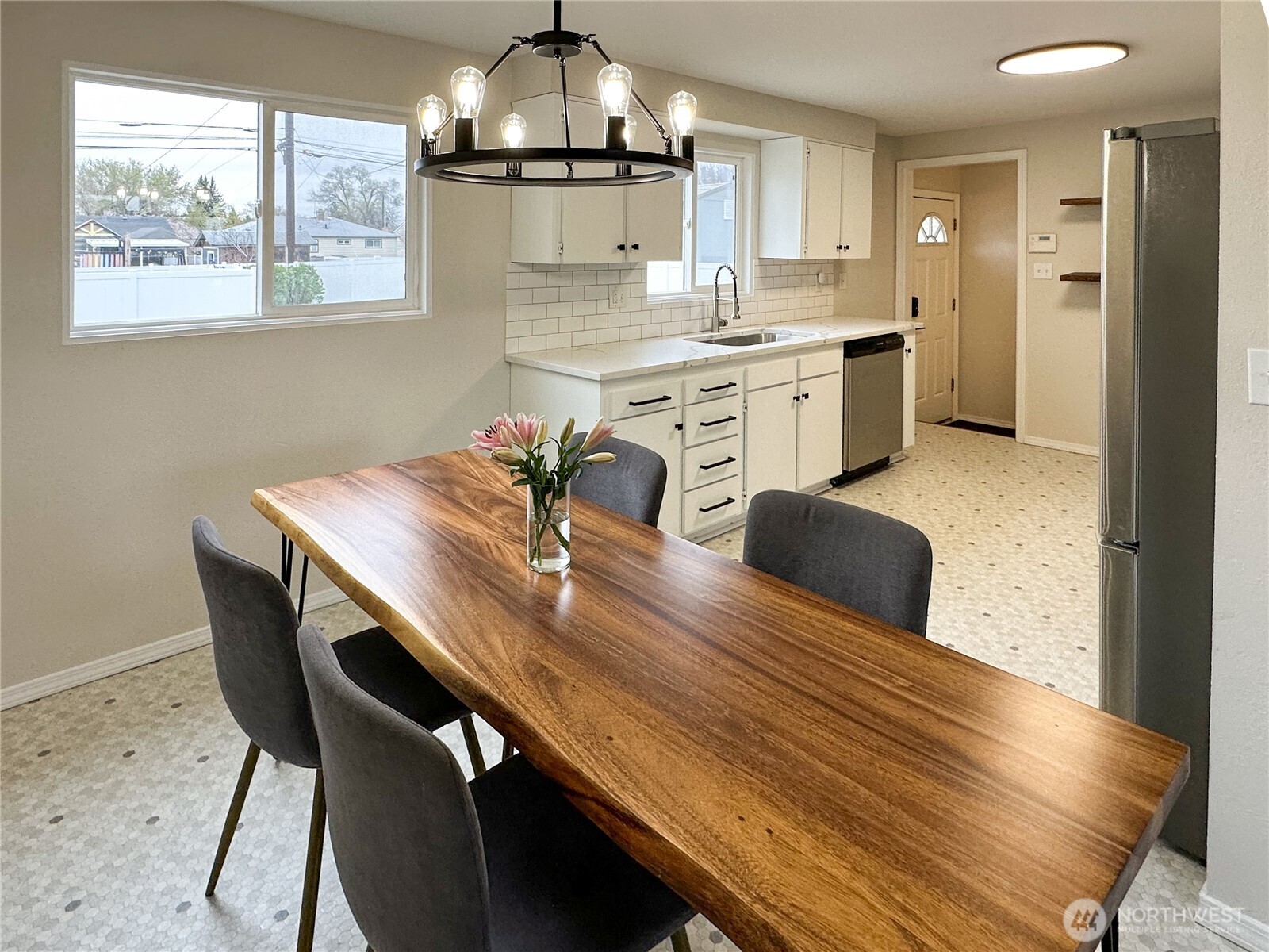 611 East Joseph Avenue Spokane, WA 99208 - Photo 5 of 29 a dining room with wooden floor a chandelier a wooden table and chairs