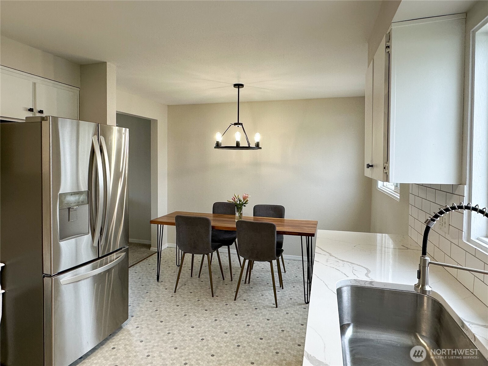 611 East Joseph Avenue Spokane, WA 99208 - Photo 7 of 29 a kitchen with stainless steel appliances granite countertop a dining table and chairs