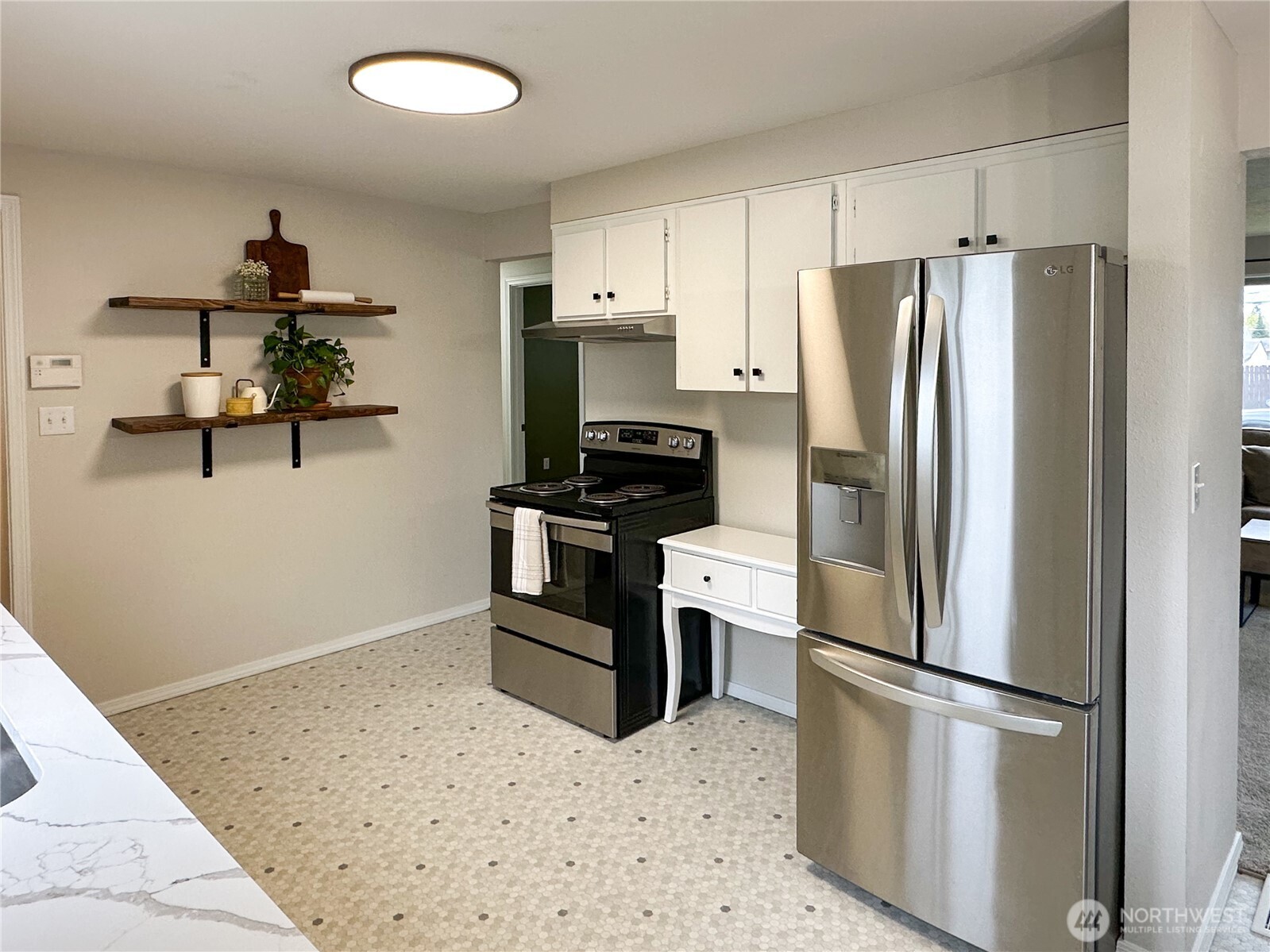 611 East Joseph Avenue Spokane, WA 99208 - Photo 9 of 29 a kitchen with stainless steel appliances a refrigerator a stove a microwave and a refrigerator