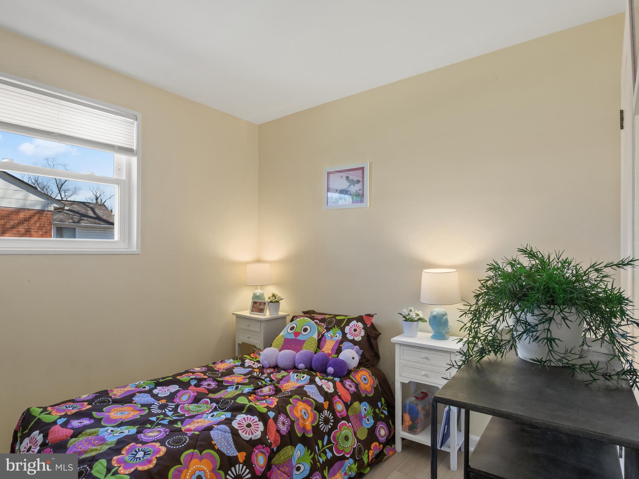 3405 Fredale Street Silver Spring, MD 20906 - Photo 15 of 34 a bedroom with a bed and a potted plant