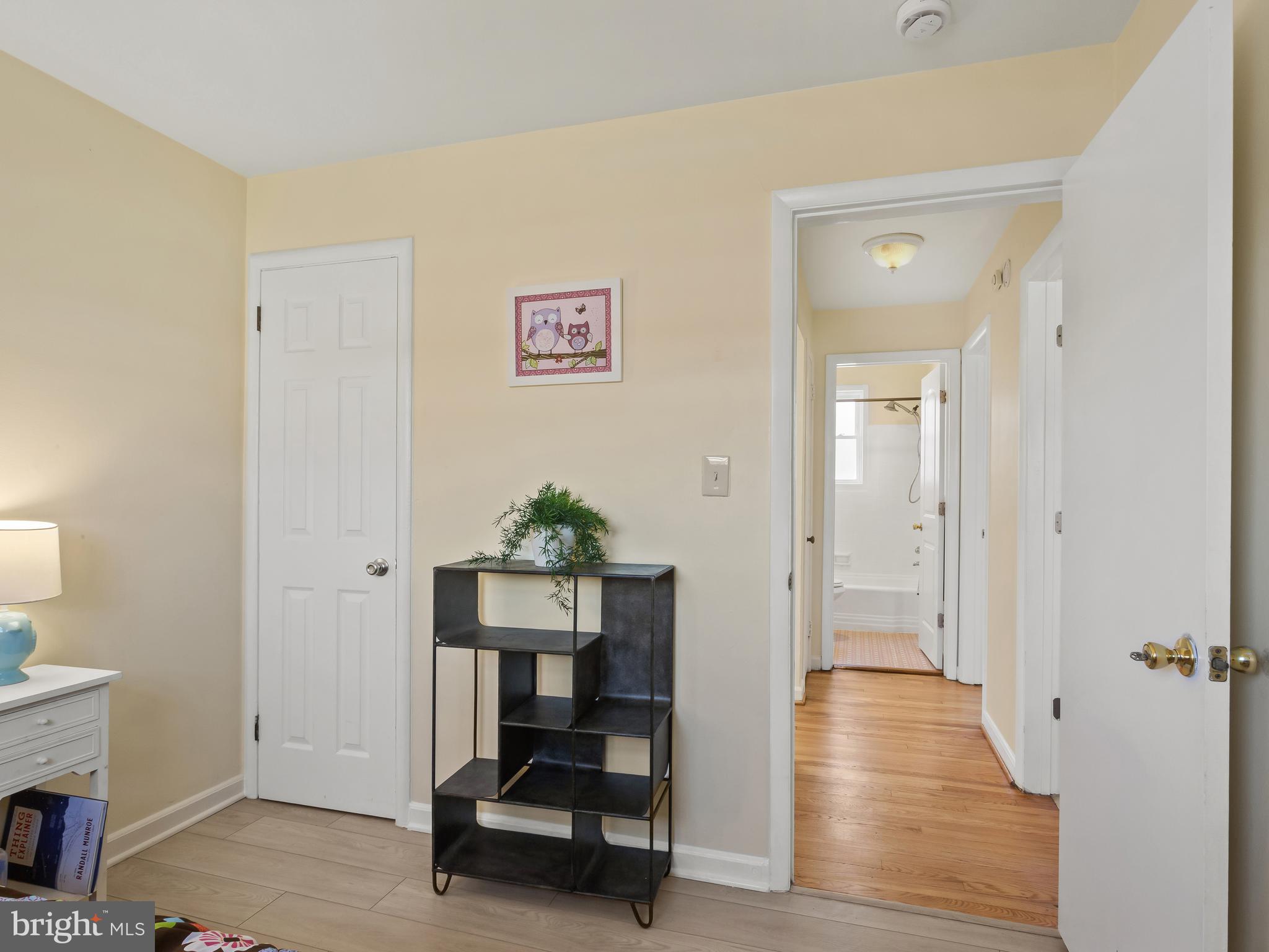 3405 Fredale Street Silver Spring, MD 20906 - Photo 16 of 34 a view of a hallway with wooden floor and furniture