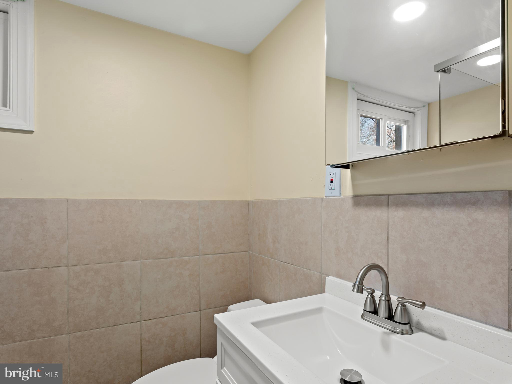 3405 Fredale Street Silver Spring, MD 20906 - Photo 26 of 34 a bathroom with a sink and mirror
