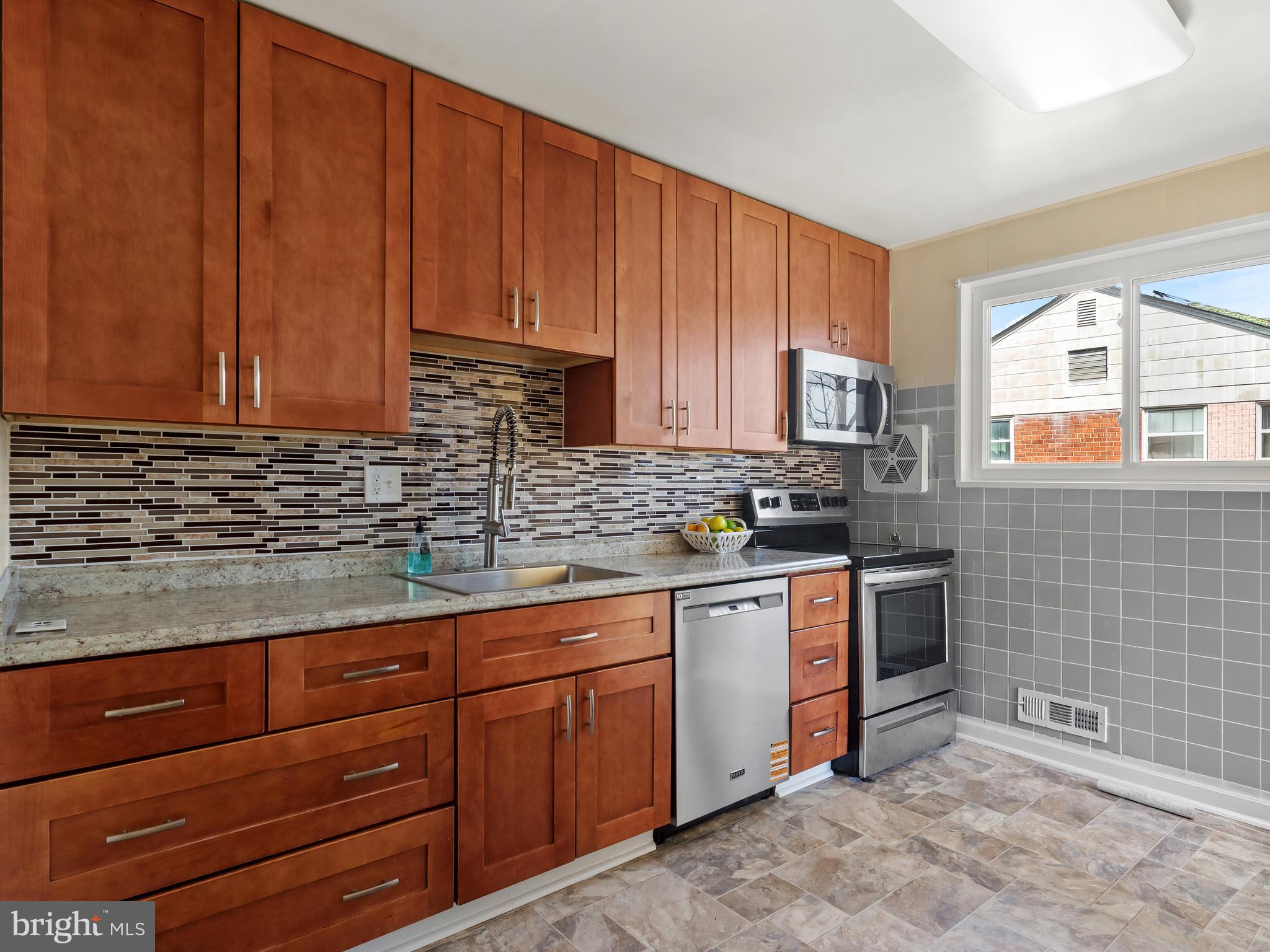 3405 Fredale Street Silver Spring, MD 20906 - Photo 8 of 34 a kitchen with stainless steel appliances granite countertop wooden cabinets a sink and dishwasher