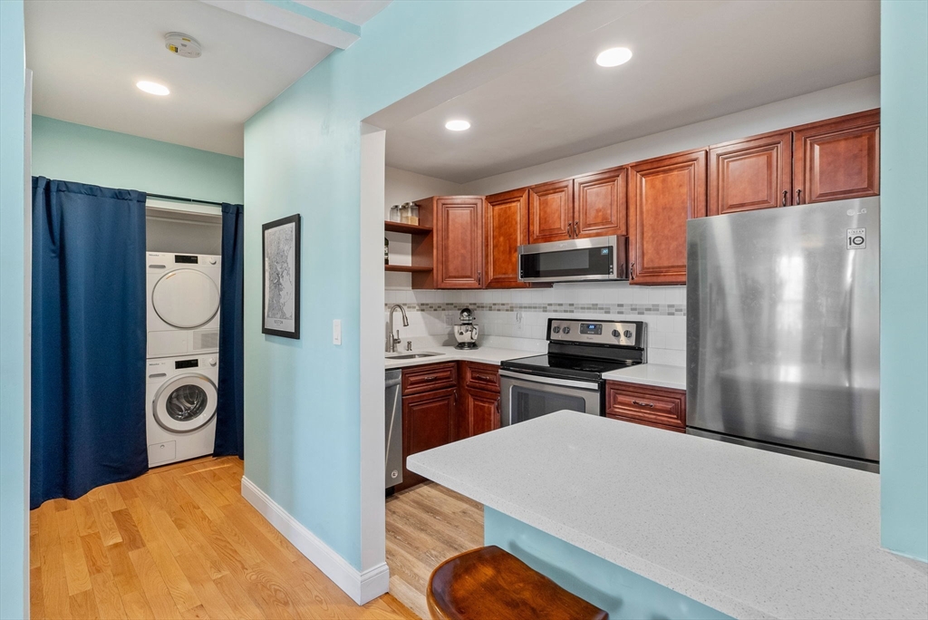 69 East Berkeley Street, Unit 5 Boston, MA 02118 - Photo 12 of 27 a kitchen with stainless steel appliances a refrigerator a stove a sink and a refrigerator