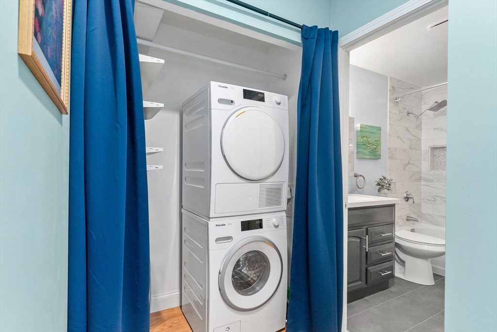 69 East Berkeley Street, Unit 5 Boston, MA 02118 - Photo 14 of 27 a view of a bathroom with washing machine and a sink